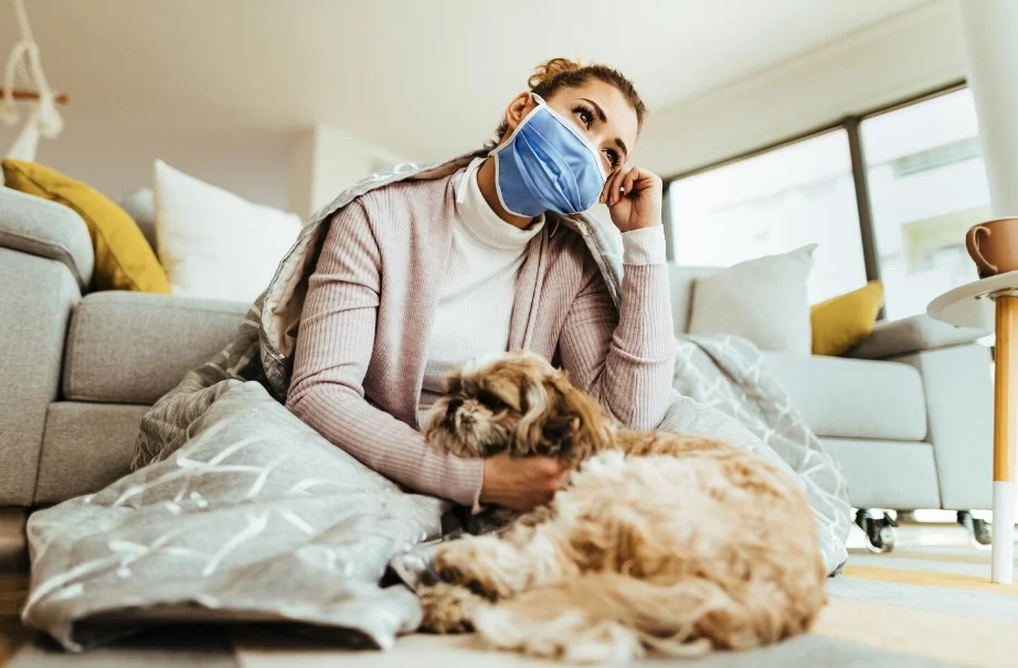 woman with flu sitting with her dog